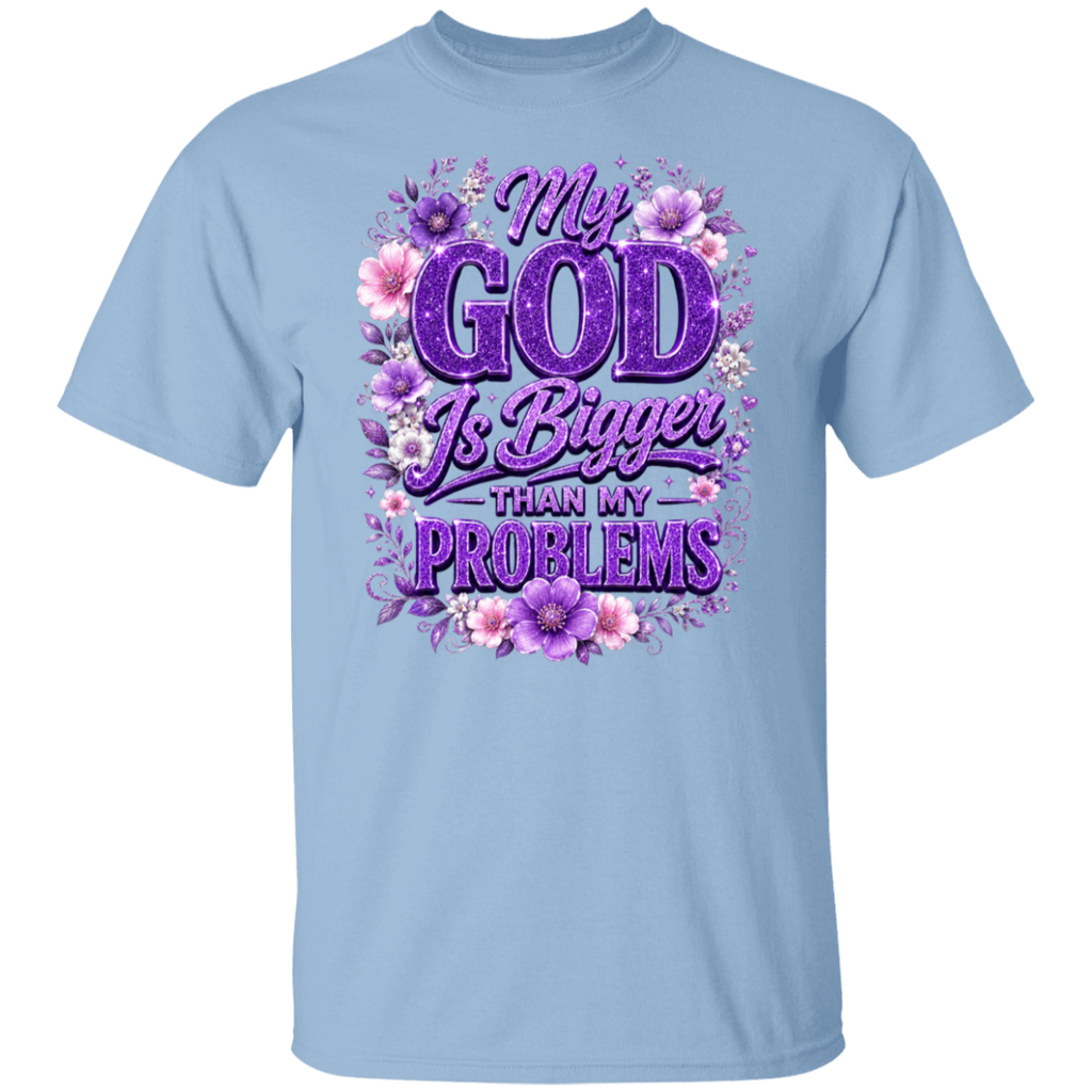 A light blue short-sleeve crewneck t-shirt featuring a purple and pink graphic print on the front with the text 'My GOD Is Bigger THAN MY PROBLEMS' surrounded by purple and pink flowers.